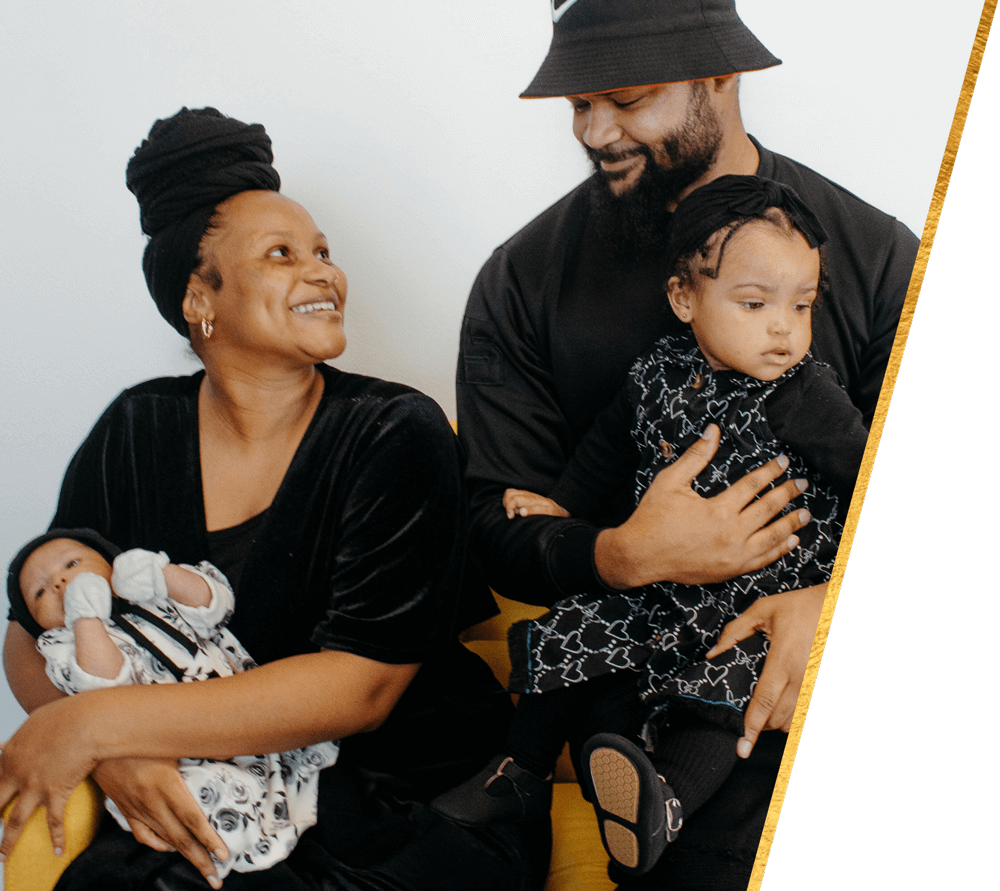 Ujima Scholarship Arkansas Doula. Image of happy family with new baby and toddler.